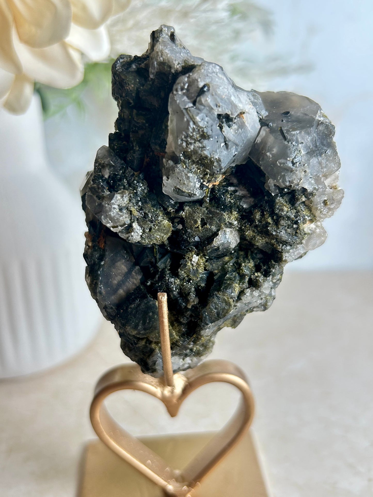 Natural tourmaline and epidote crystal cluster specimen on gold display stand with deep green epidote crystals.