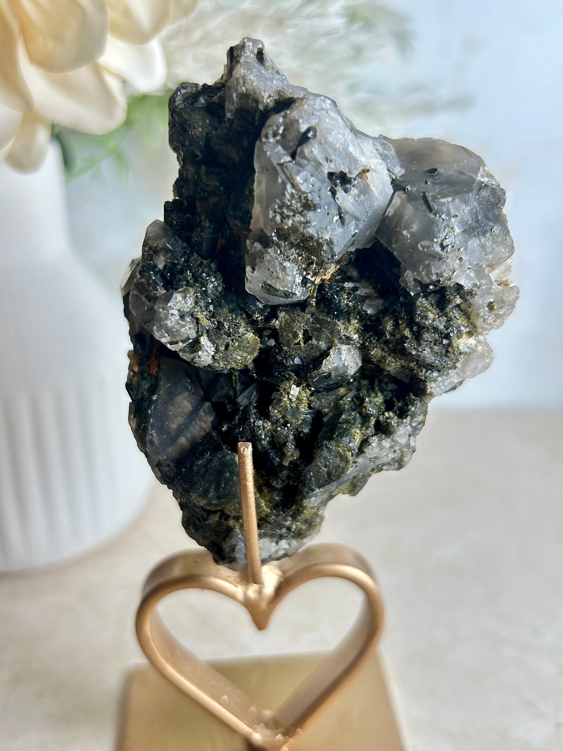 Natural tourmaline and epidote crystal cluster specimen on gold display stand with deep green epidote crystals.