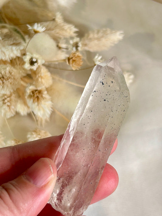 Clear Quartz point with blue inclusions, Anatase or Hematite