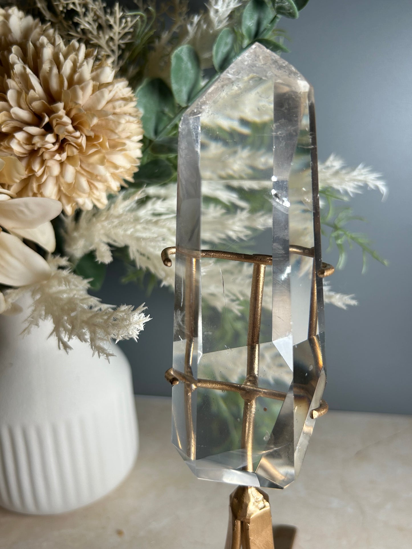 high grade polished clear quartz freeform crystal on gold display stand natural quartz specimen