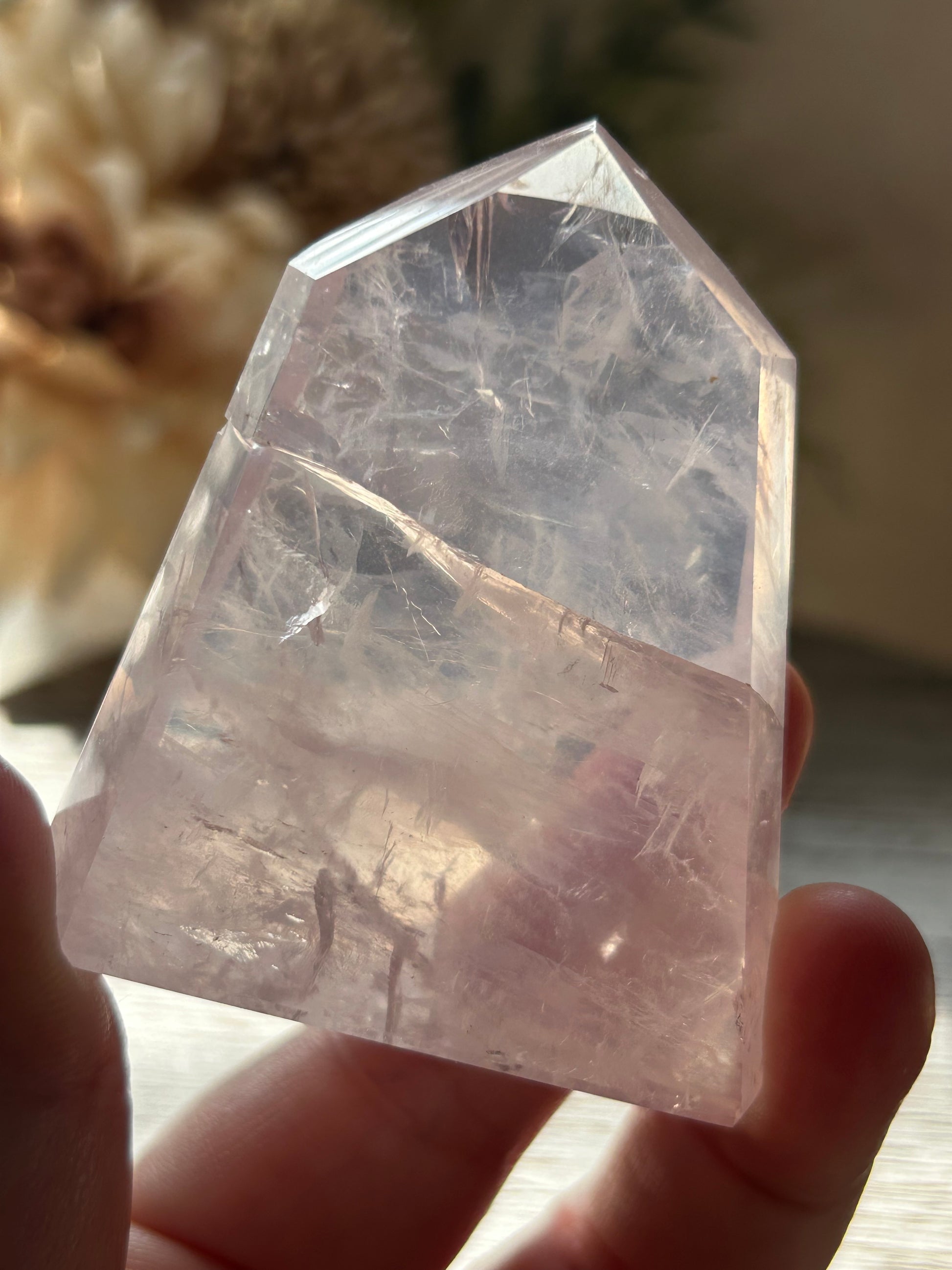 Crystal held in hand with a blurred background