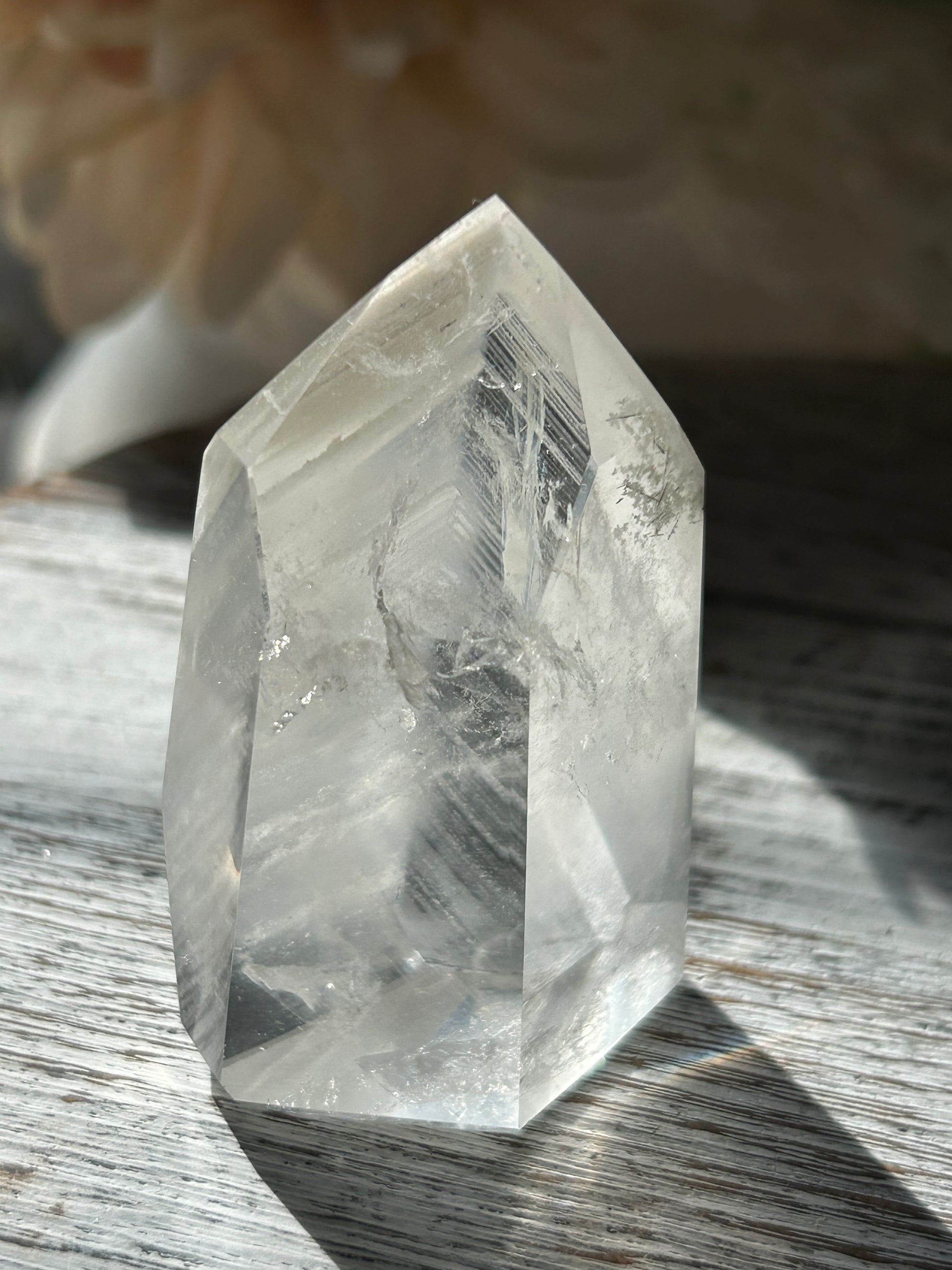 Polished Phantom Quartz tower with layered ghost-like inclusions and natural internal formations