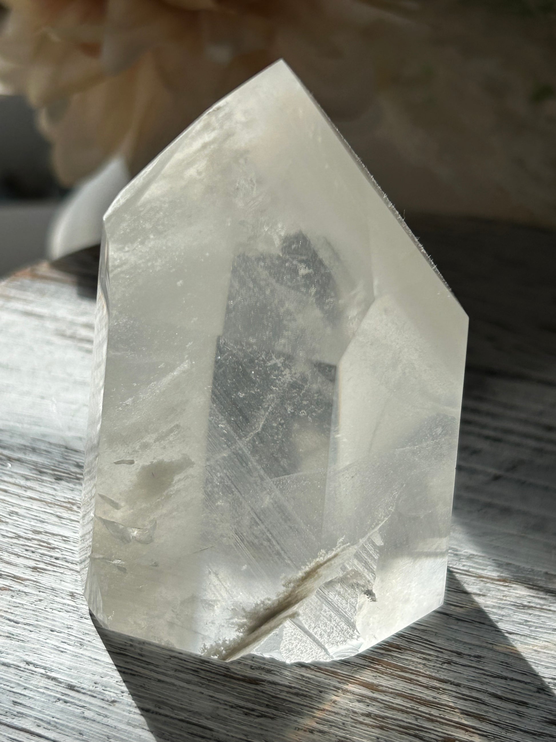 Polished Phantom Quartz tower with layered ghost-like inclusions and natural internal formations