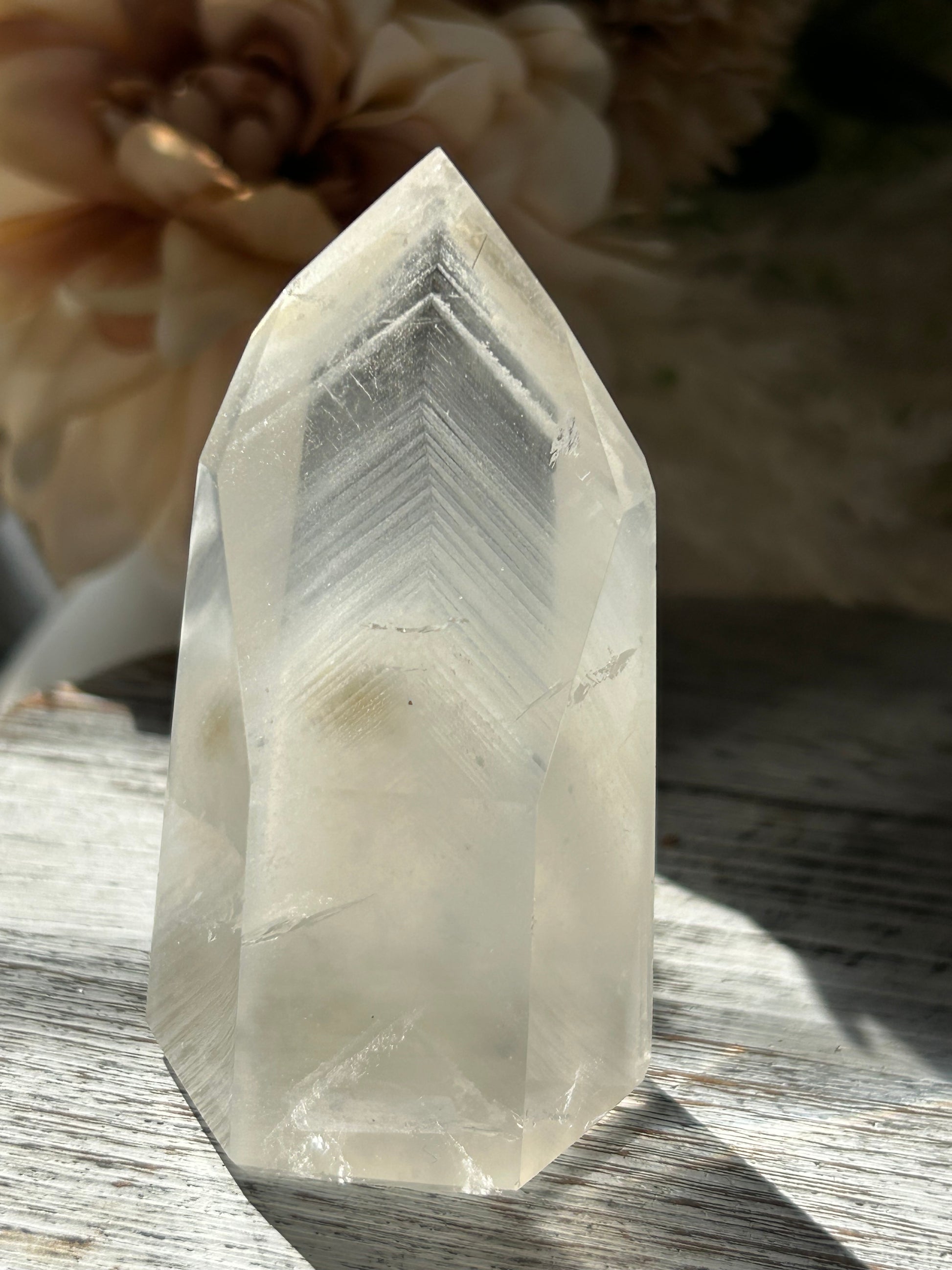 Polished Phantom Quartz tower with layered ghost-like inclusions and natural internal formations