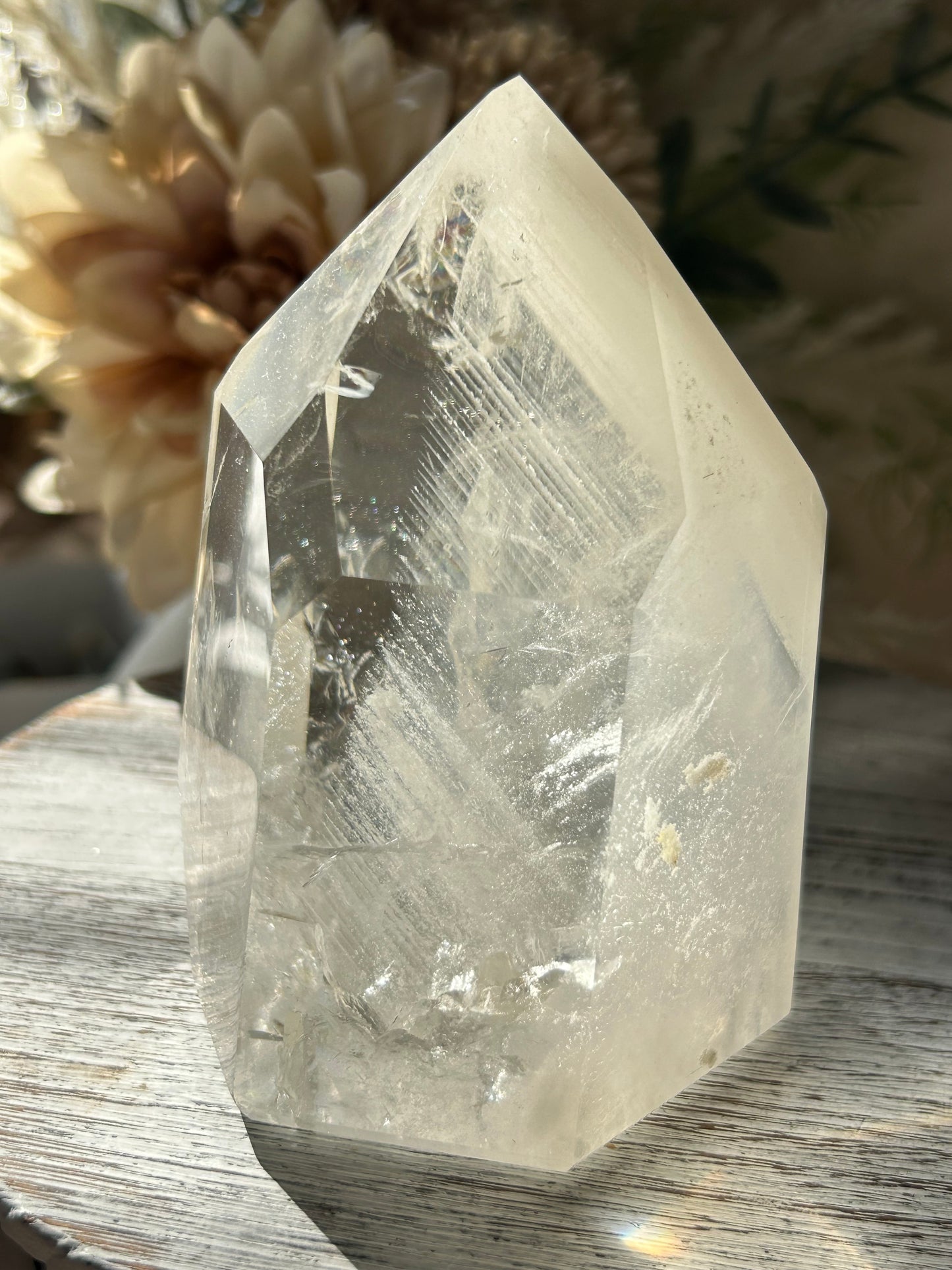 Polished Phantom Quartz tower with layered ghost-like inclusions and natural internal formations