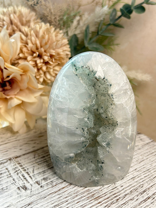 Polished Rainbow Amethyst freeform with sparkling druzy vein, pale translucent quartz tones, and natural crystal texture.