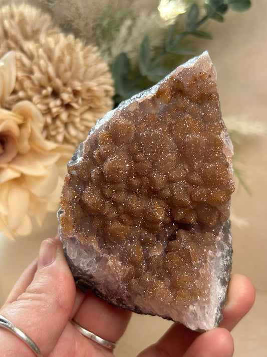 Raw Orange Sugar Druzy Rainbow Amethyst with sparkling textured crystal formations and warm amber tones.