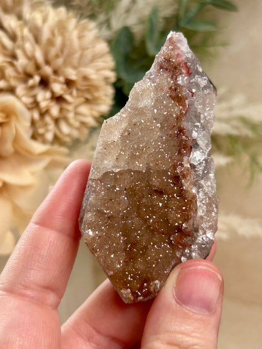 Raw Orange Rainbow Amethyst druzy point with sparkling amber crystal texture and natural earthy tones.