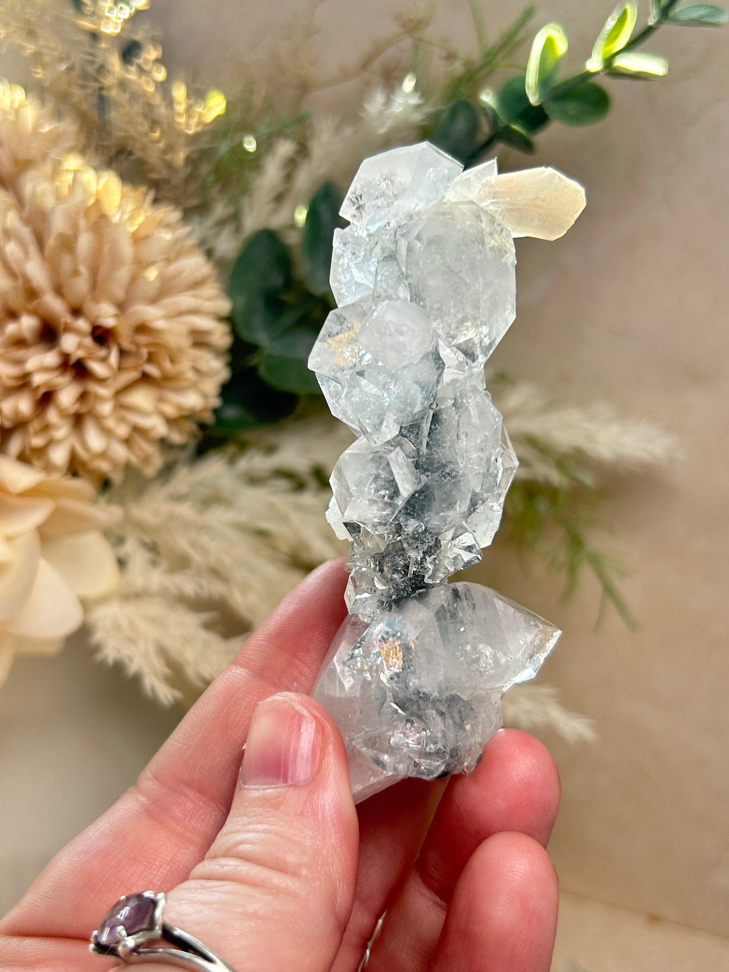 Natural Apophyllite stalactite with sparkling crystal texture and layered mineral formation.