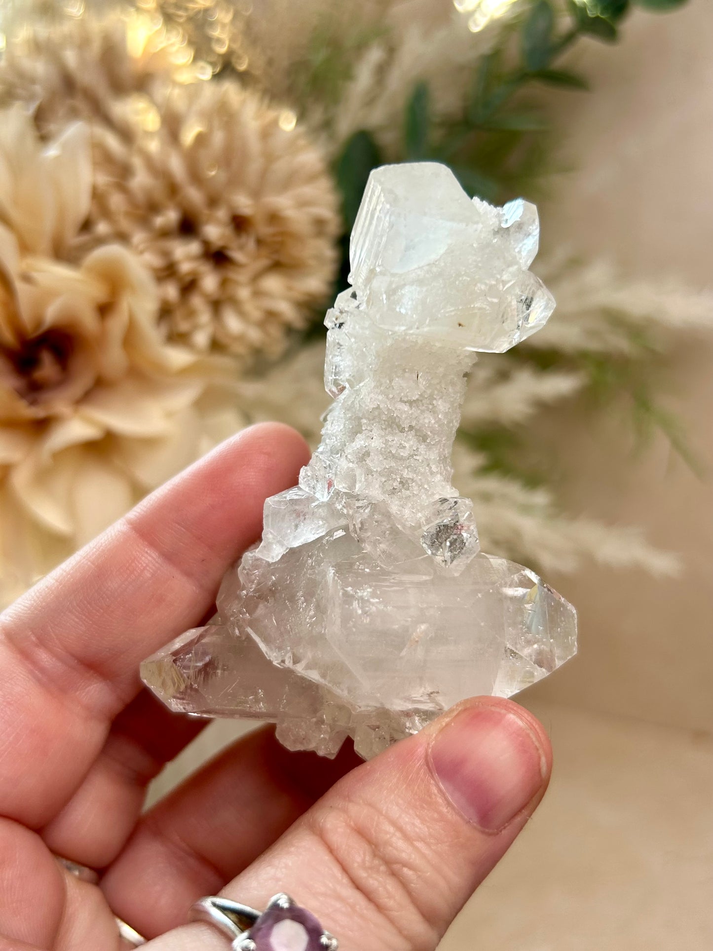 Natural Apophyllite stalactite with sparkling crystal texture and layered mineral formation.