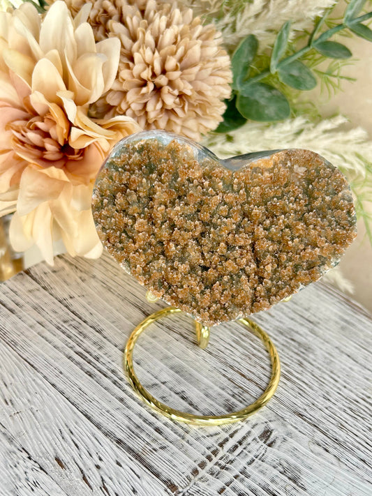 Mustard sugar druzy Rainbow Amethyst heart with sparkling golden crystal texture and gold display stand.