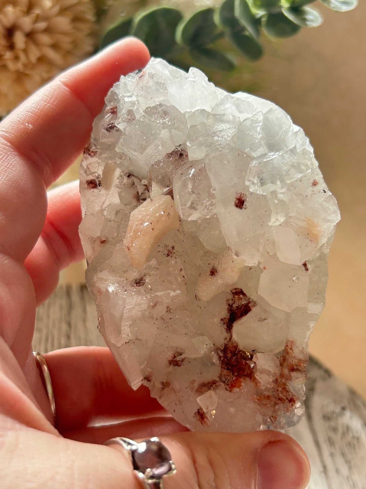 Crystal rock held in hands with a blurred natural background