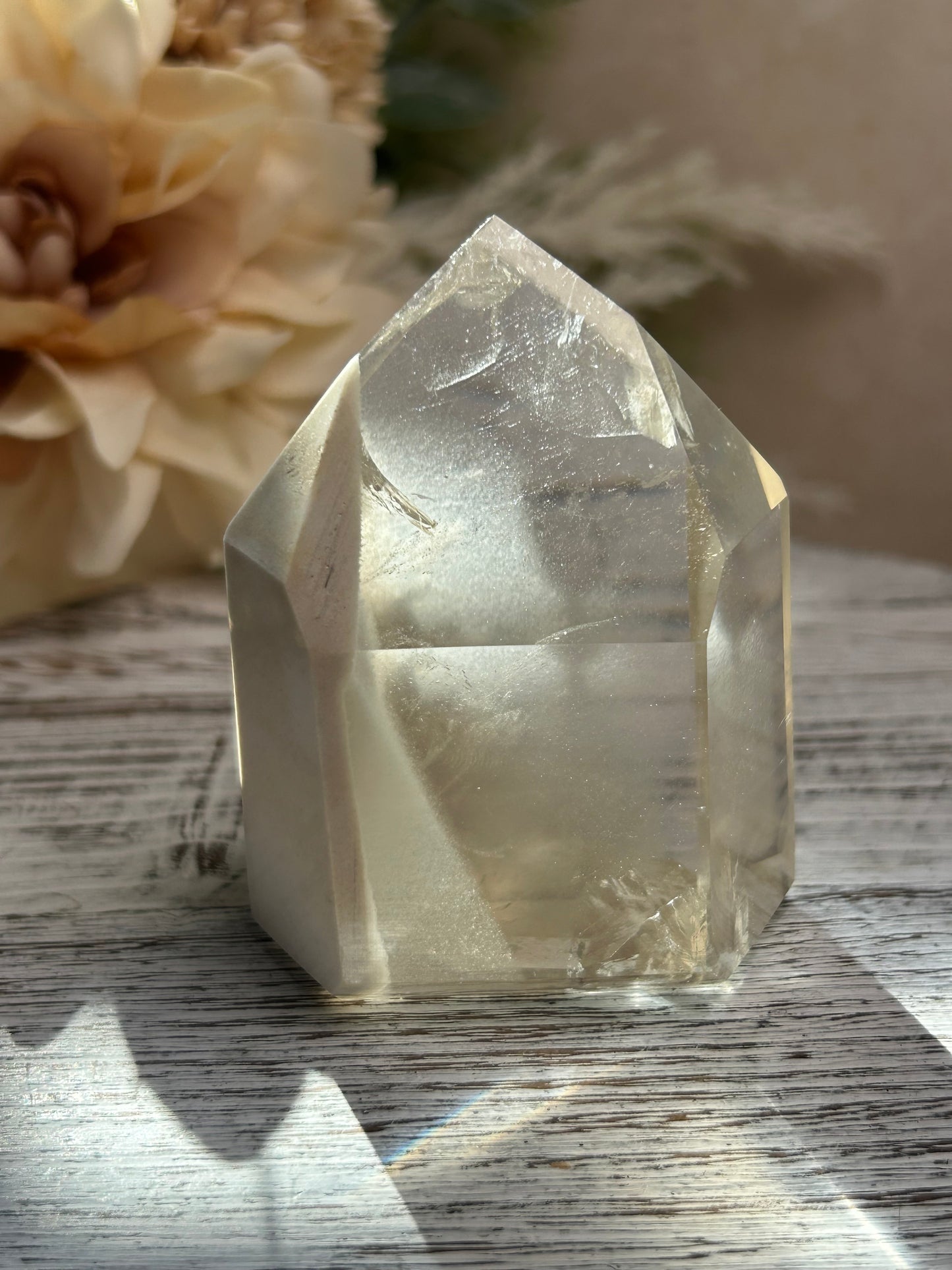 Clear crystal on a wooden surface with a blurred background