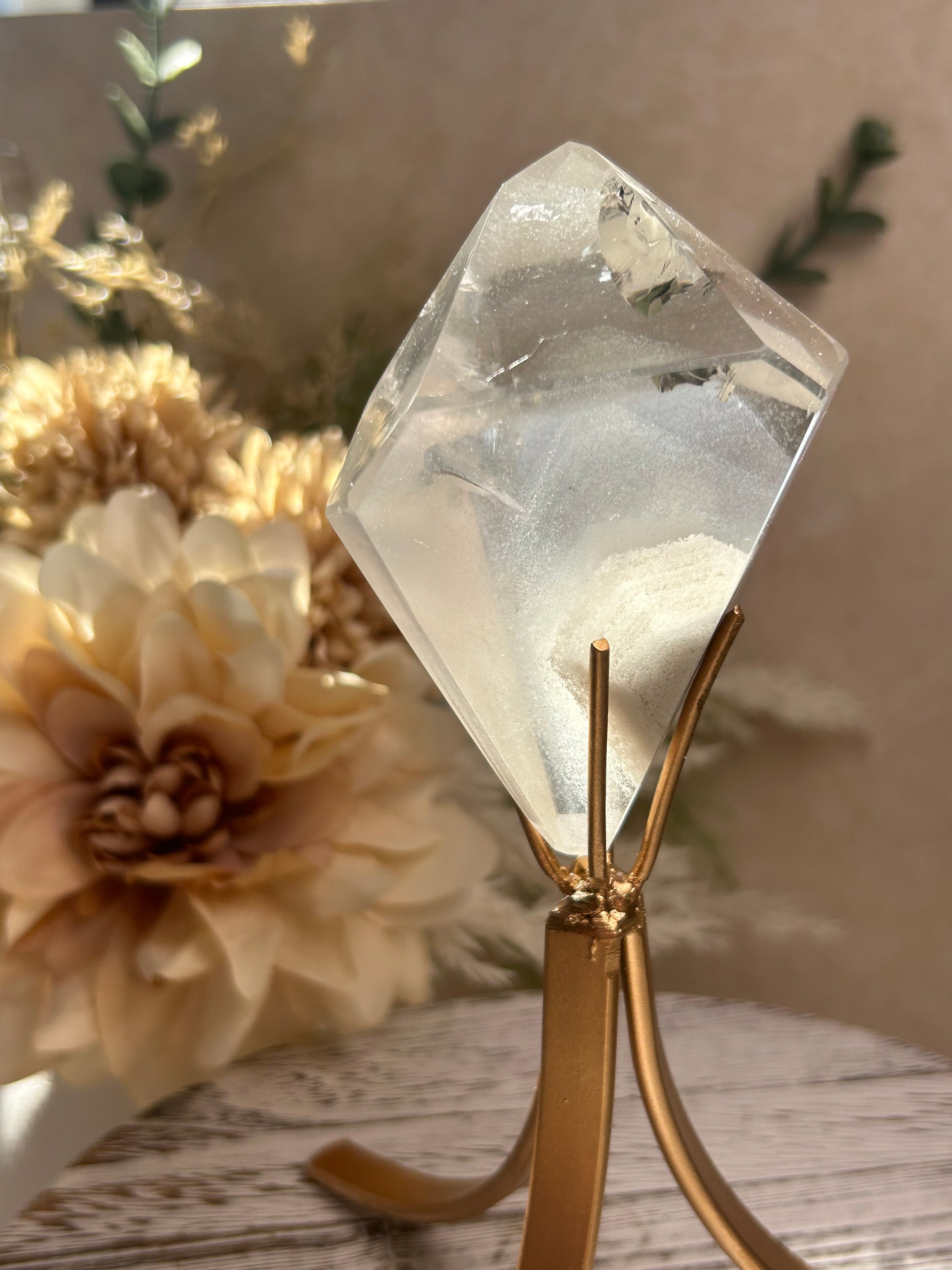 Phantom Quartz crystal specimen mounted on a custom display stand, showcasing visible phantom formations within the Quartz. Collector mineral specimen with unique internal crystal growth patterns.