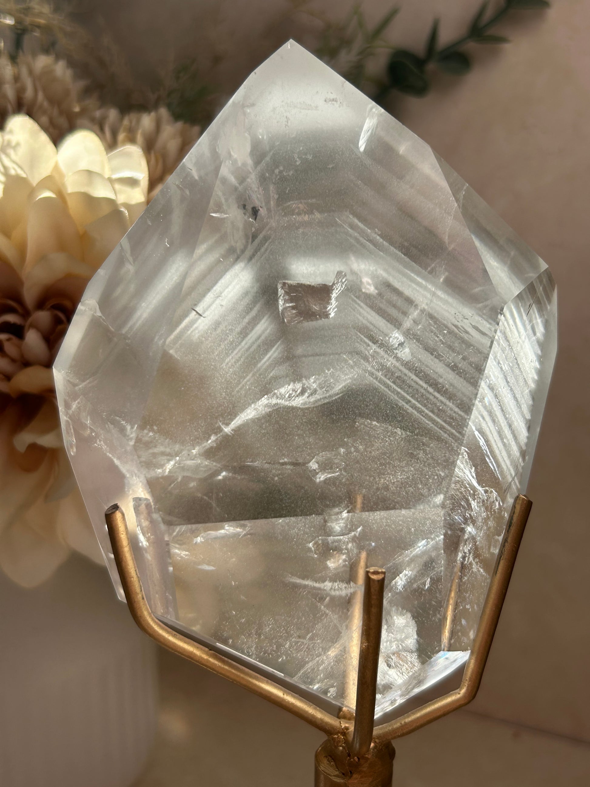 Phantom Quartz crystal specimen mounted on a custom display stand, showcasing visible phantom formations within the Quartz. Collector mineral specimen with unique internal crystal growth patterns.