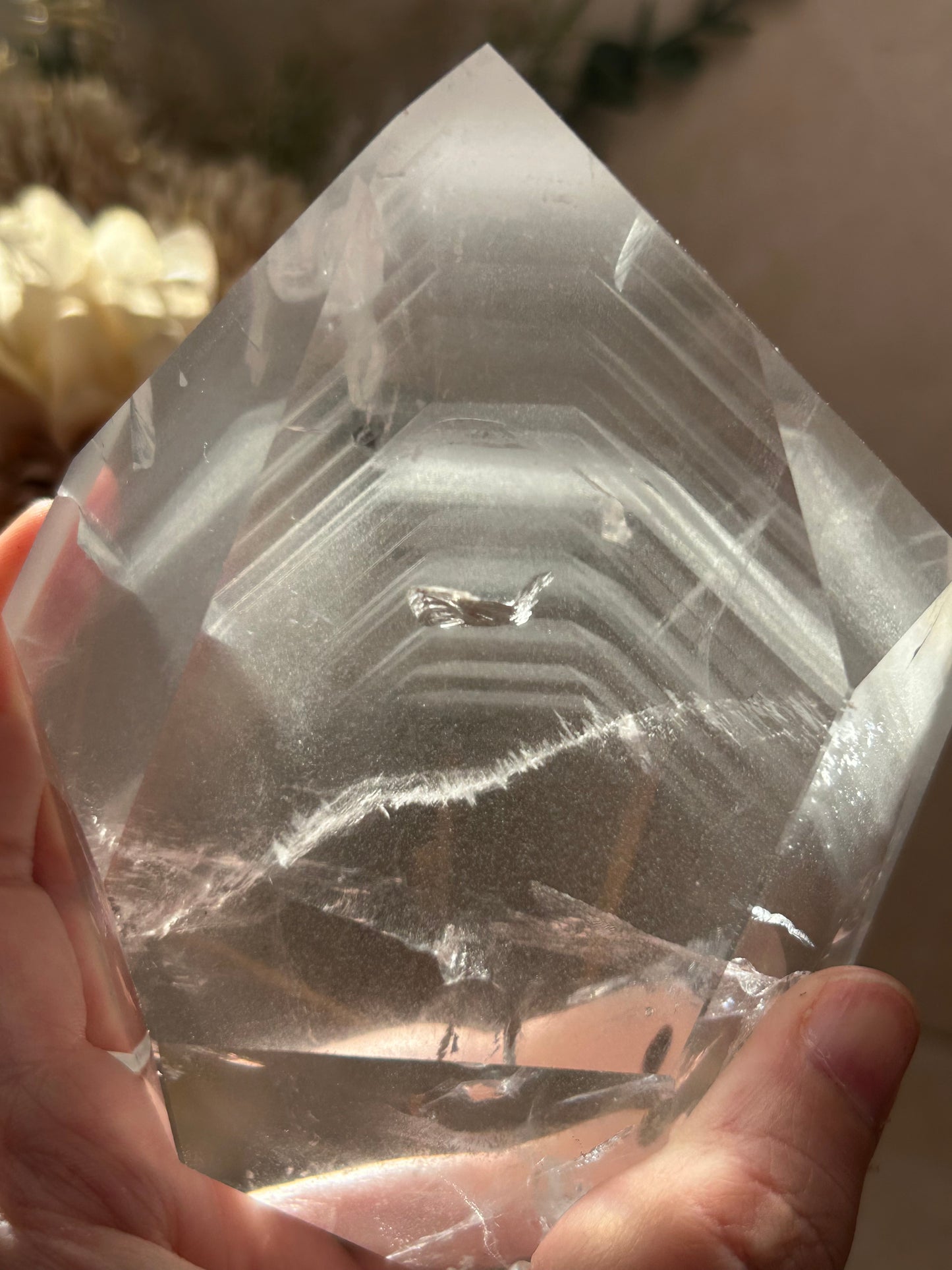 Phantom Quartz crystal specimen mounted on a custom display stand, showcasing visible phantom formations within the Quartz. Collector mineral specimen with unique internal crystal growth patterns.