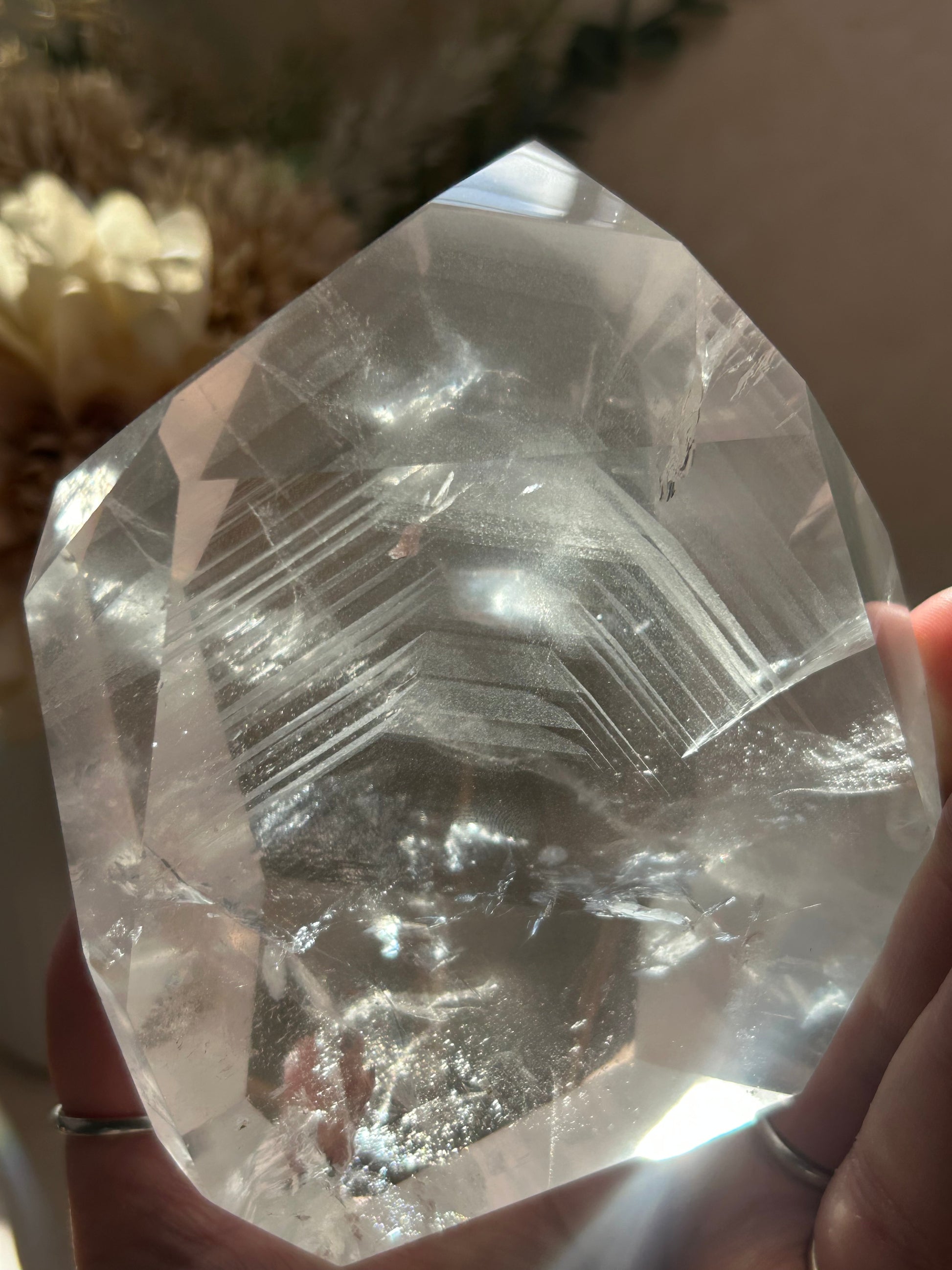 Phantom Quartz crystal specimen mounted on a custom display stand, showcasing visible phantom formations within the Quartz. Collector mineral specimen with unique internal crystal growth patterns.
